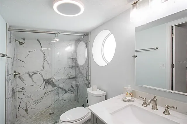 a bathroom with a sink toilet and shower