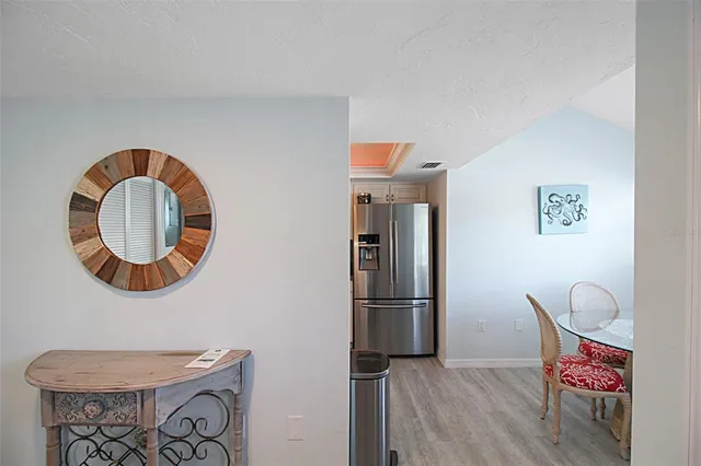 a kitchen with stainless steel appliances granite countertop a refrigerator and a stove