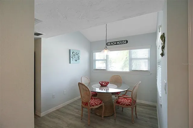 a dining room with furniture and window