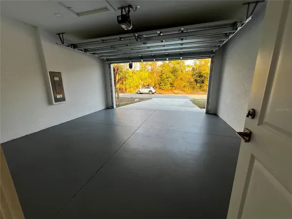 a view of empty room with wooden floor and windows
