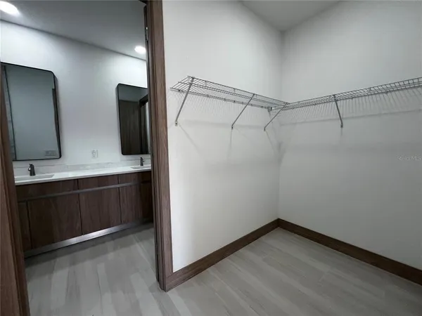 a bathroom with a double vanity sink and mirror