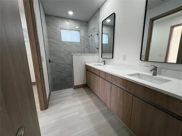 a bathroom with a double vanity sink a and mirror