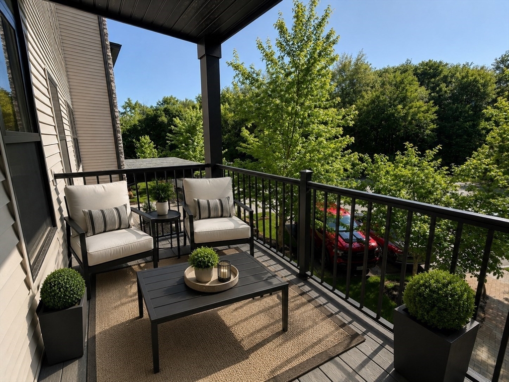 269 Main Street, Unit 2006 Reading, MA 01867 - Photo 10 of 10 a view of a balcony with chairs and wooden floor