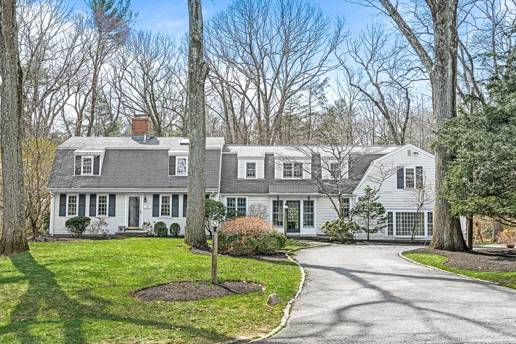 a front view of a residential houses with yard and green space