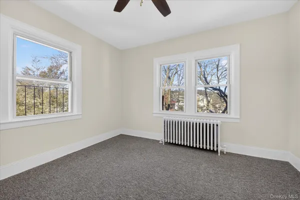 an empty room with windows and closet