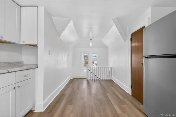 a view of hallway with wooden floor