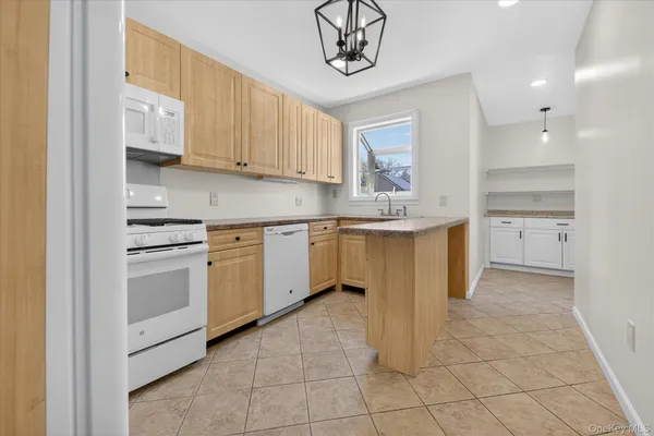 a kitchen with a stove sink and cabinets