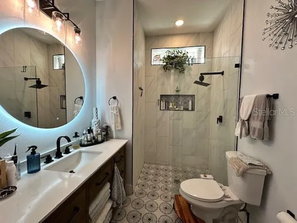 a bathroom with a double vanity sink mirror and toilet