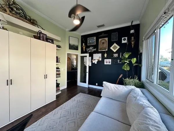 a living room with stainless steel appliances furniture and a large window