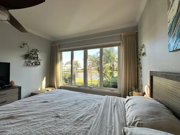 a bedroom with a large bed and a large window