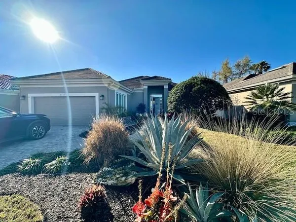 a front view of a house with a yard and a garage