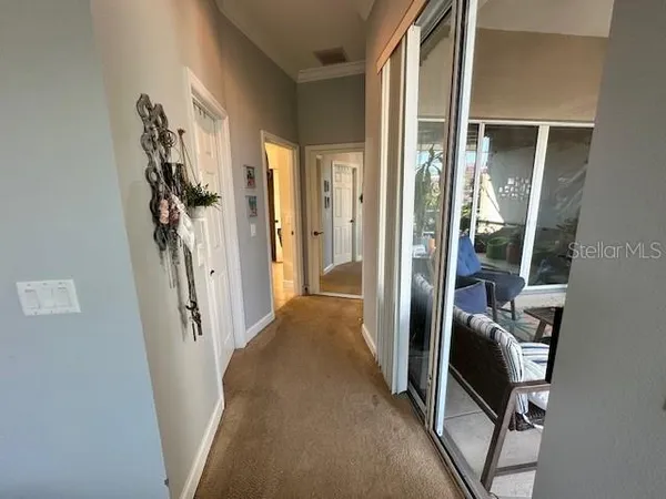 a view of a hallway with furniture and front door