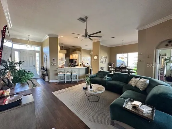 a living room with furniture and wooden floor