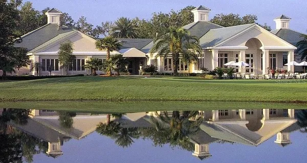 a front view of a house with a garden and trees