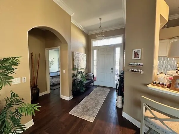 a living room with furniture and a chandelier