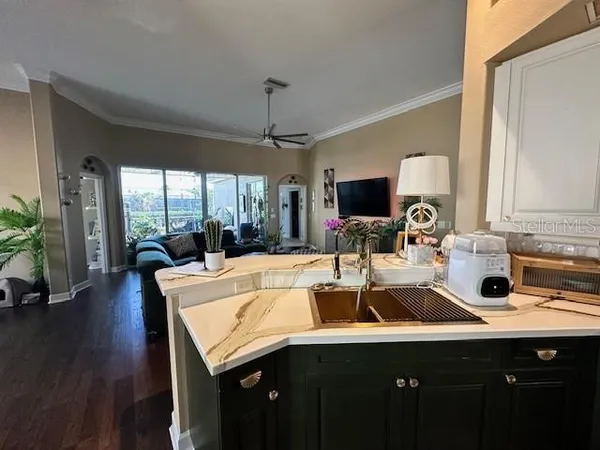a kitchen with a sink appliances and a large window