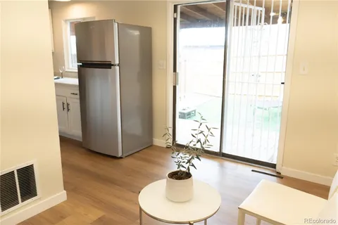 a kitchen with a refrigerator and a sink