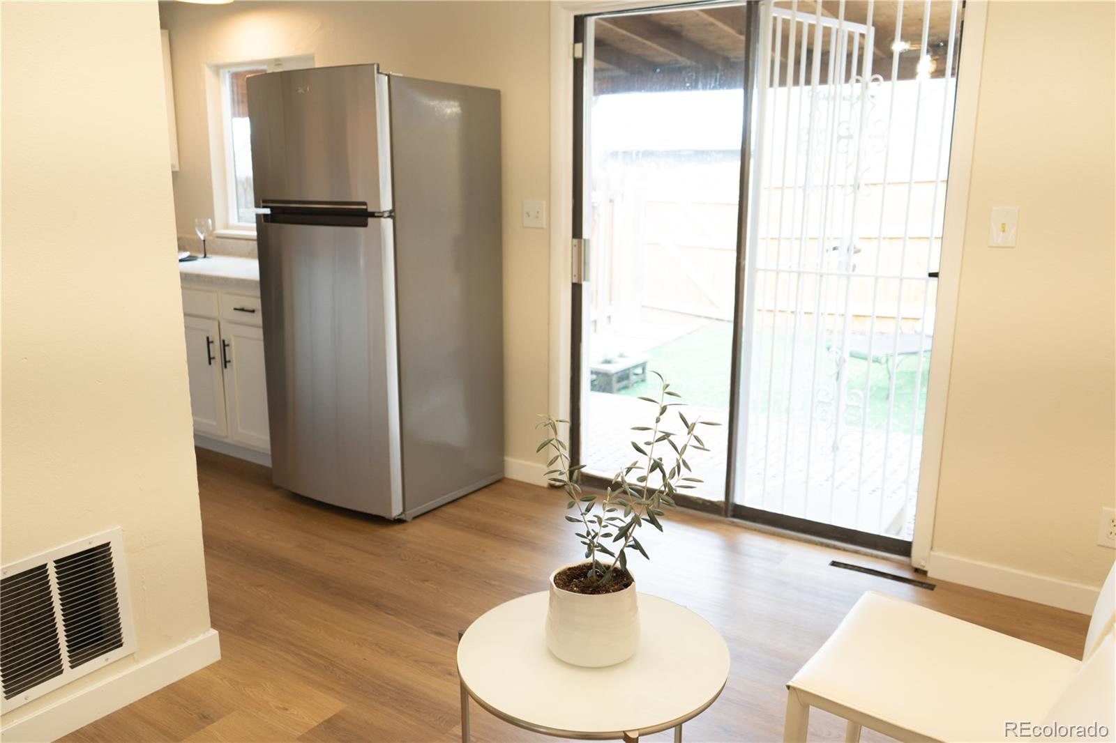 3073 West Center Avenue, Unit C Denver, CO 80219 - Photo 12 of 34 a kitchen with a refrigerator and a sink