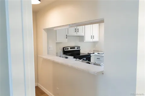 a kitchen with a refrigerator and a stove