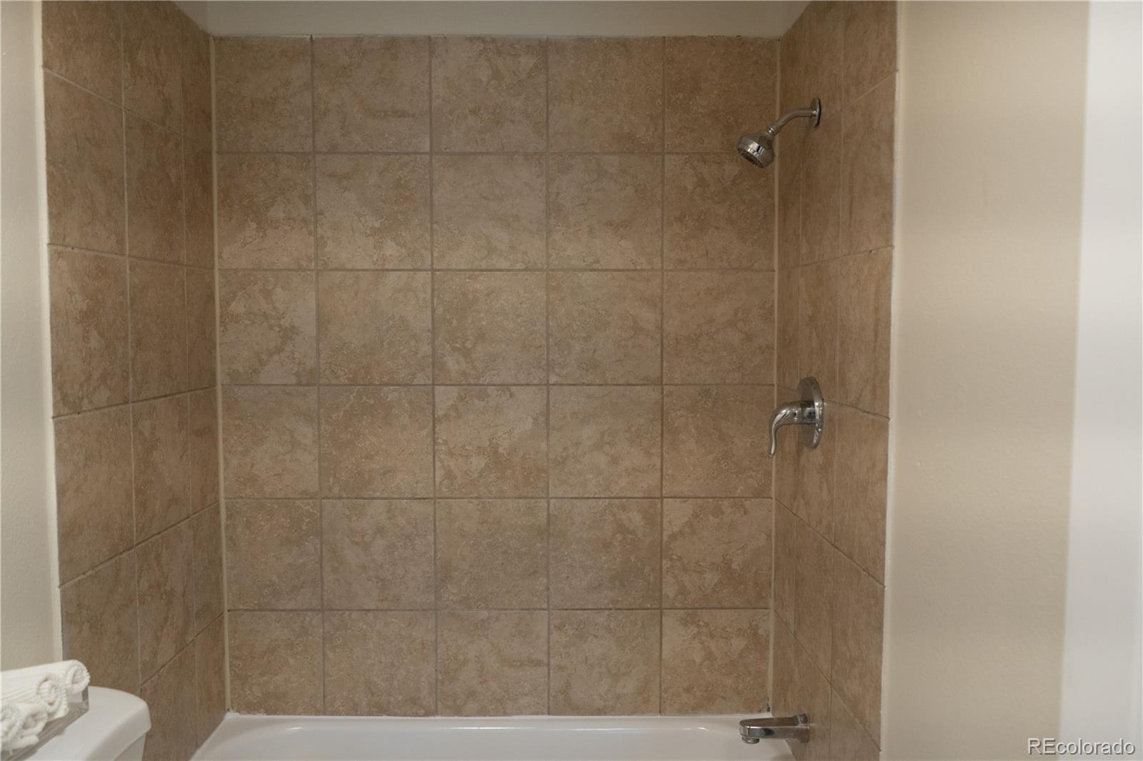 3073 West Center Avenue, Unit C Denver, CO 80219 - Photo 27 of 34 a bathroom with a shower