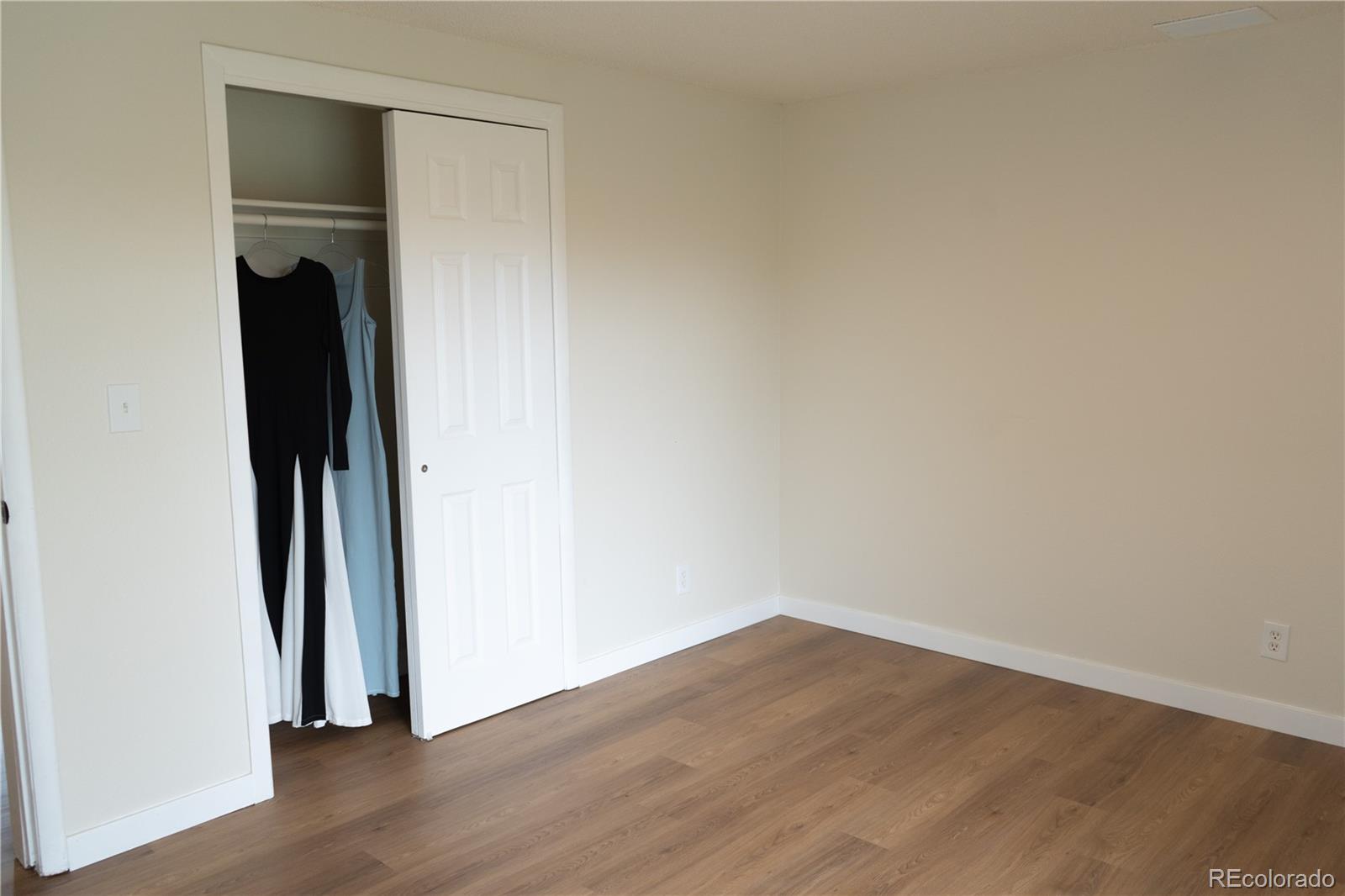 3073 West Center Avenue, Unit C Denver, CO 80219 - Photo 33 of 34 an empty room with wooden floor and closet