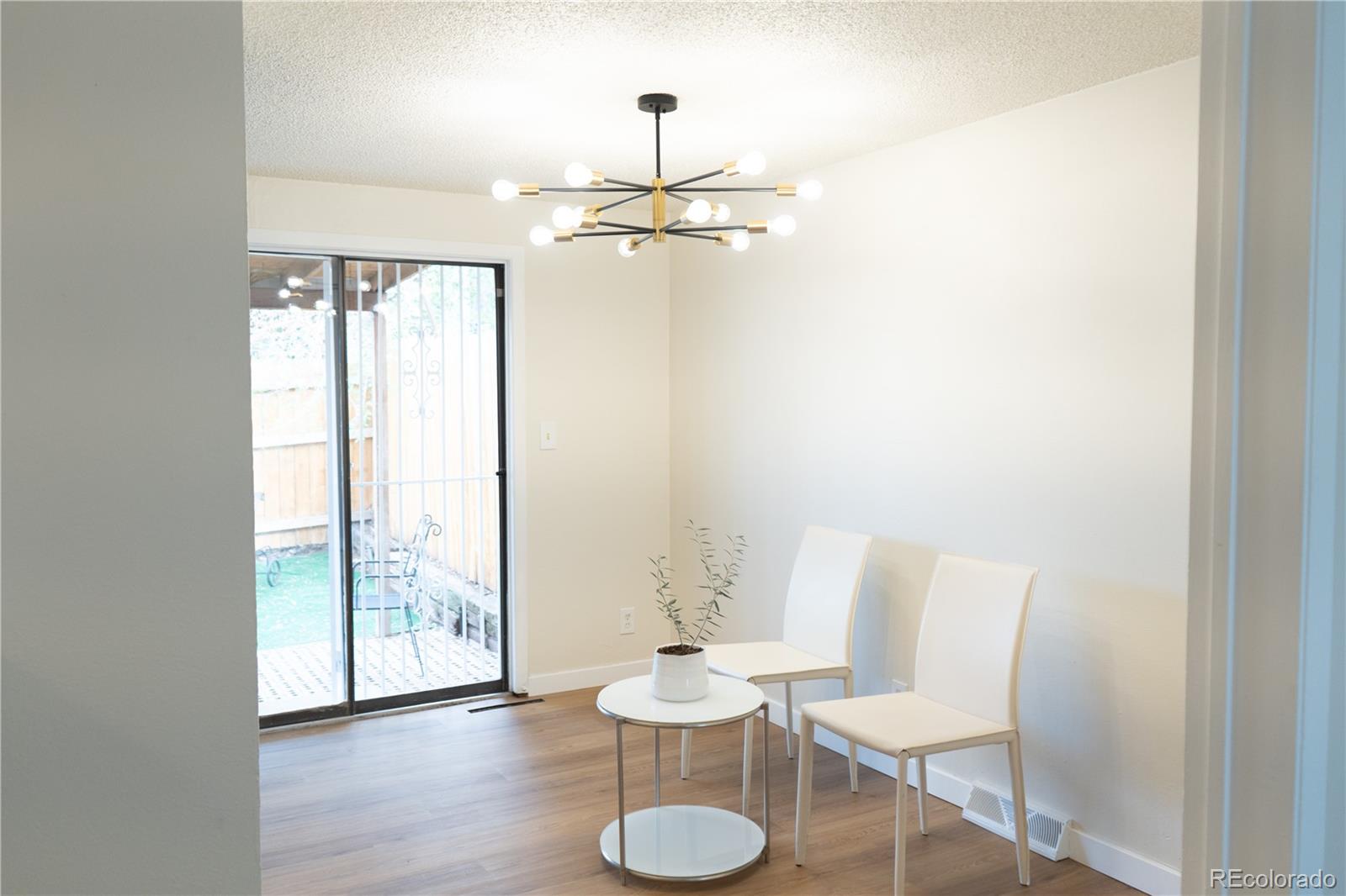 3073 West Center Avenue, Unit C Denver, CO 80219 - Photo 6 of 34 a view of a room with furniture and a potted plant