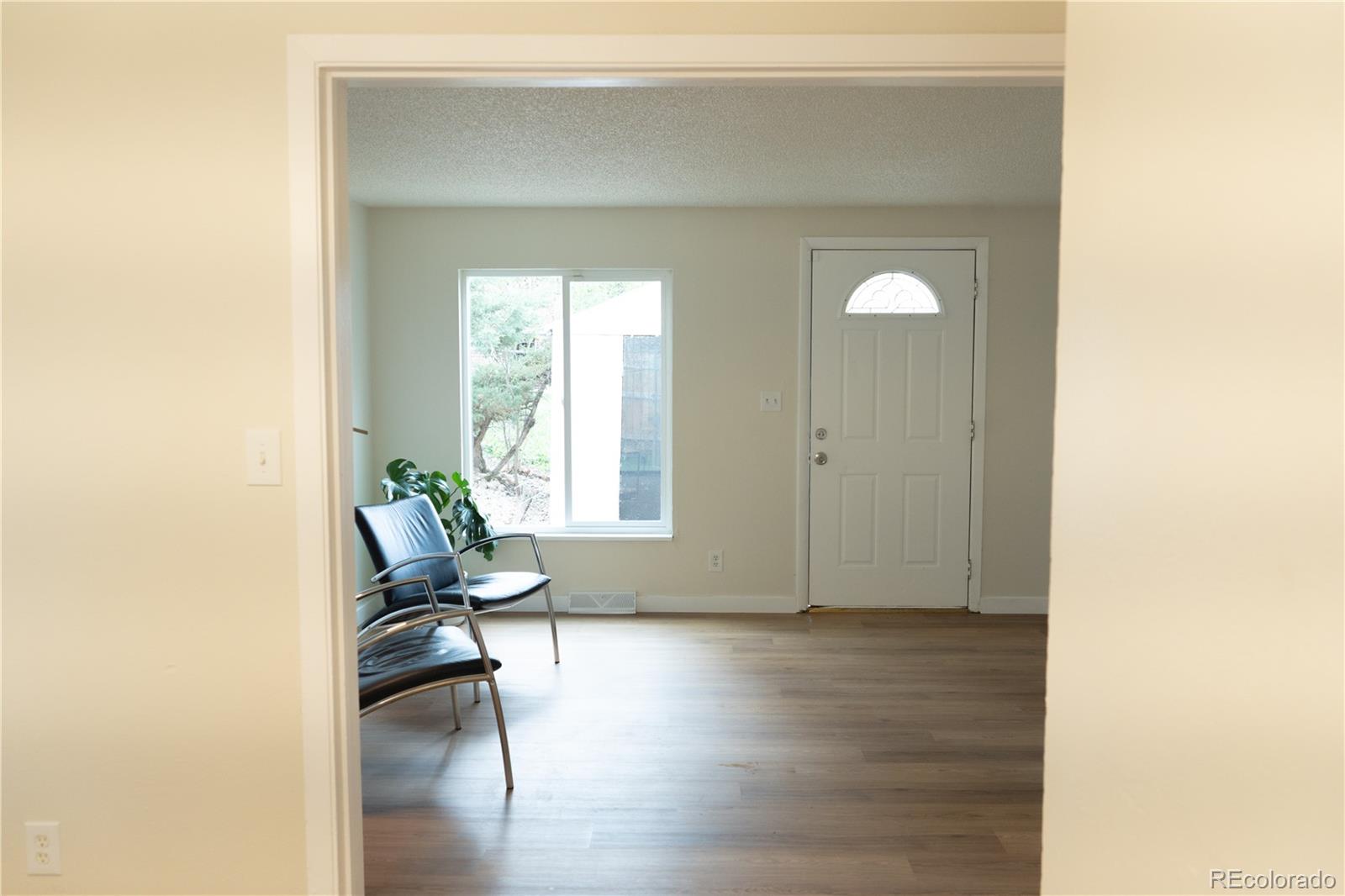 3073 West Center Avenue, Unit C Denver, CO 80219 - Photo 7 of 34 a living room with furniture and a window