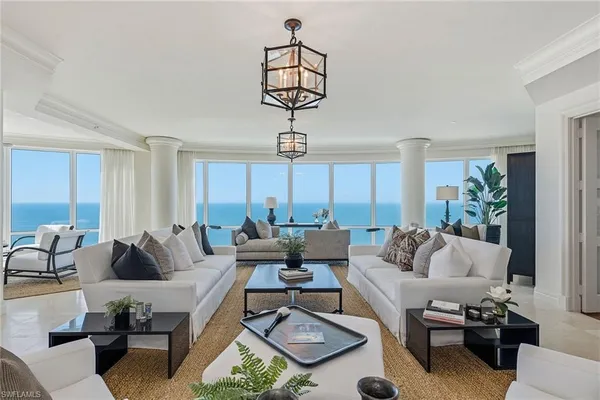 a living room with furniture or couch and a chandelier