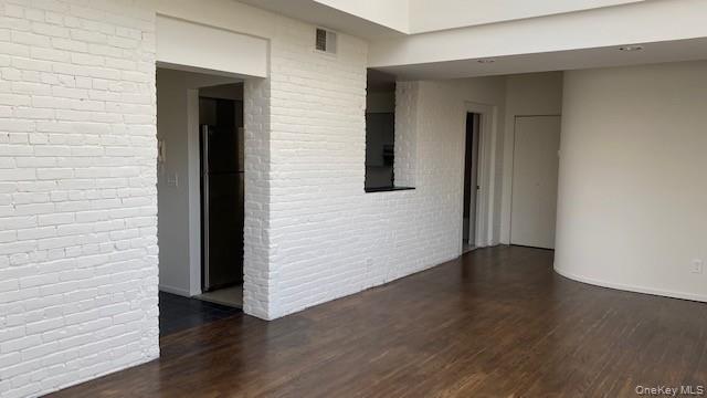 110 Mill Street, Unit 4E Poughkeepsie, NY 12601 - Photo 2 of 7 an empty room with wooden floor and closet