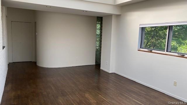 110 Mill Street, Unit 4E Poughkeepsie, NY 12601 - Photo 3 of 7 an empty room with wooden floor and windows