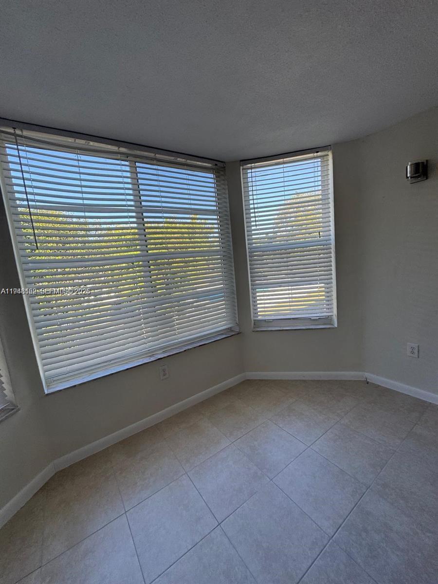 1201 Northeast 191st Street, Unit G313 Miami, FL 33179 - Photo 11 of 15 a view of an empty room with a window