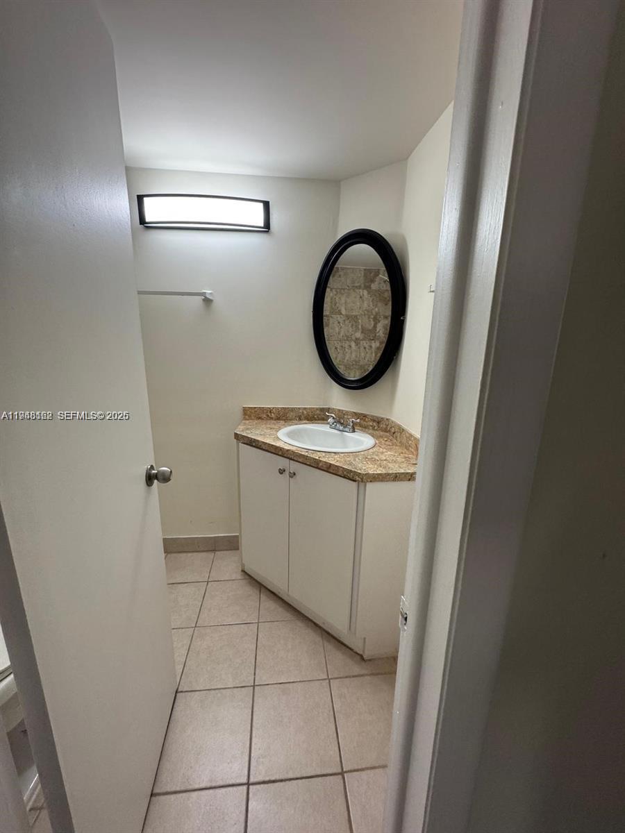 1201 Northeast 191st Street, Unit G313 Miami, FL 33179 - Photo 13 of 15 a bathroom with a toilet and a sink