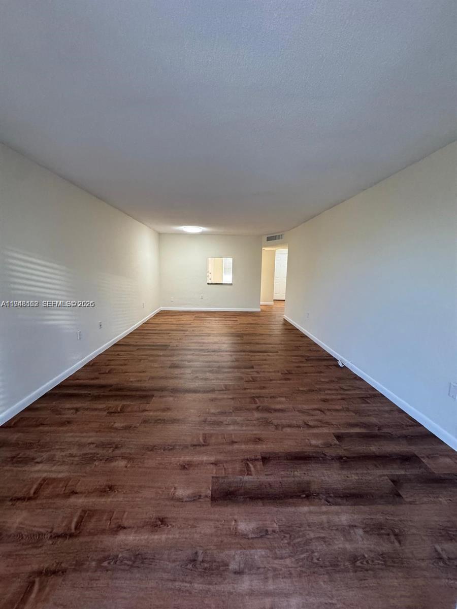 1201 Northeast 191st Street, Unit G313 Miami, FL 33179 - Photo 7 of 15 a view of an empty room
