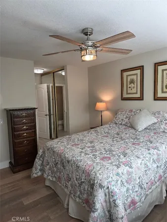 a spacious bedroom with a bed and a chandelier