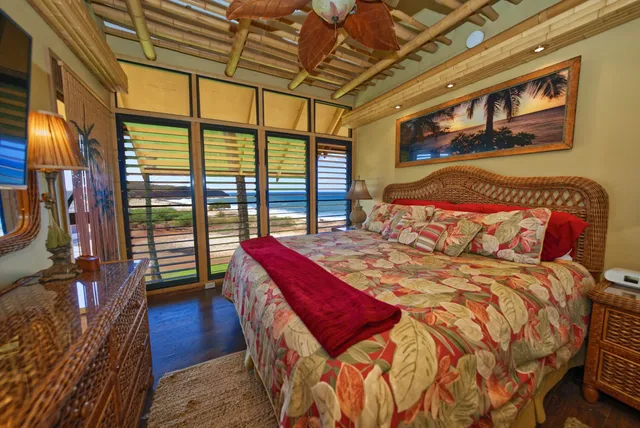 a bedroom with a bed a dresser next to a window