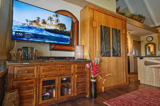 a kitchen with furniture and wooden floor