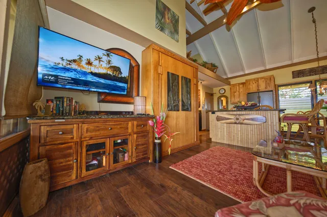 a kitchen with stainless steel appliances granite countertop a stove and a wooden floors