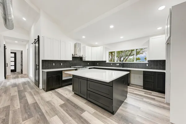 a kitchen with a stove a sink and a refrigerator