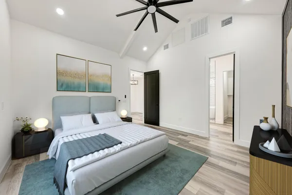 a bedroom with a bed and wooden floor