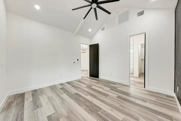 a view of an empty room with a chandelier