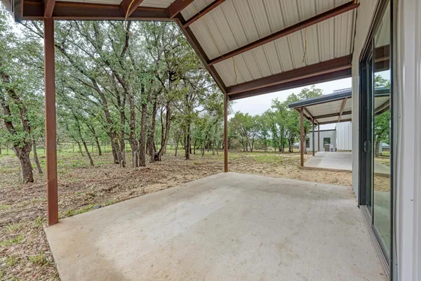 a view of a house with backyard and trees