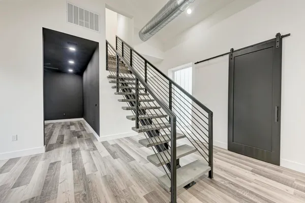 a view of entryway and hall with wooden floor