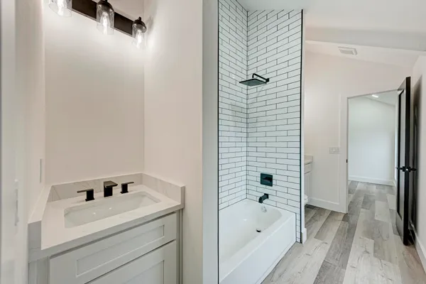 a bathroom with a bathtub and shower