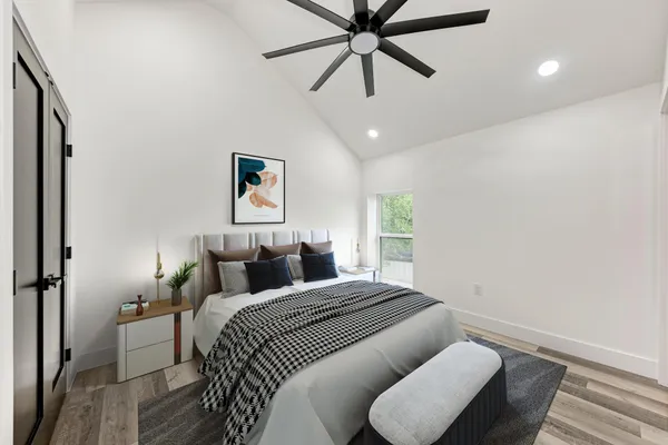 a bedroom with a bed and wooden floor