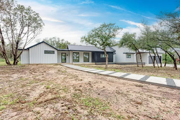 a house with trees in the background