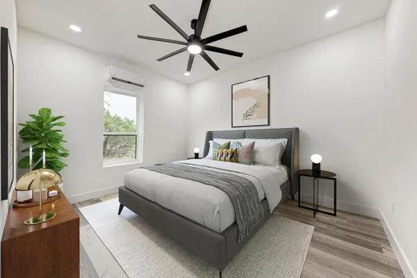 a bedroom with a bed and a potted plant