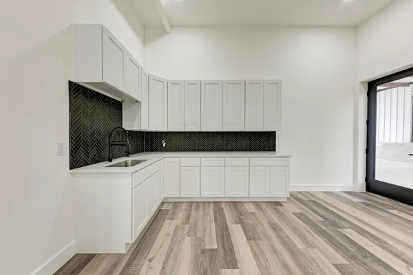 a kitchen with a sink and cabinets