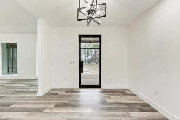 a view of a livingroom with wooden floor and a window