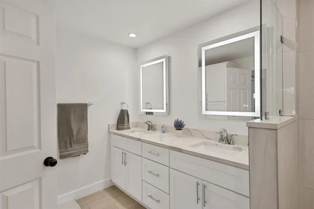 a bathroom with a granite countertop sink mirror and