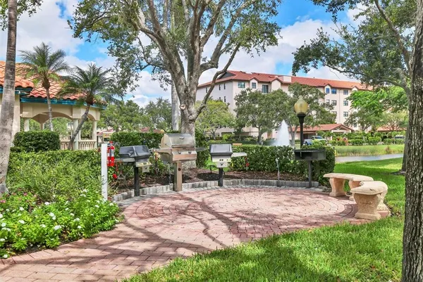 a front view of a house with a yard and a fountain